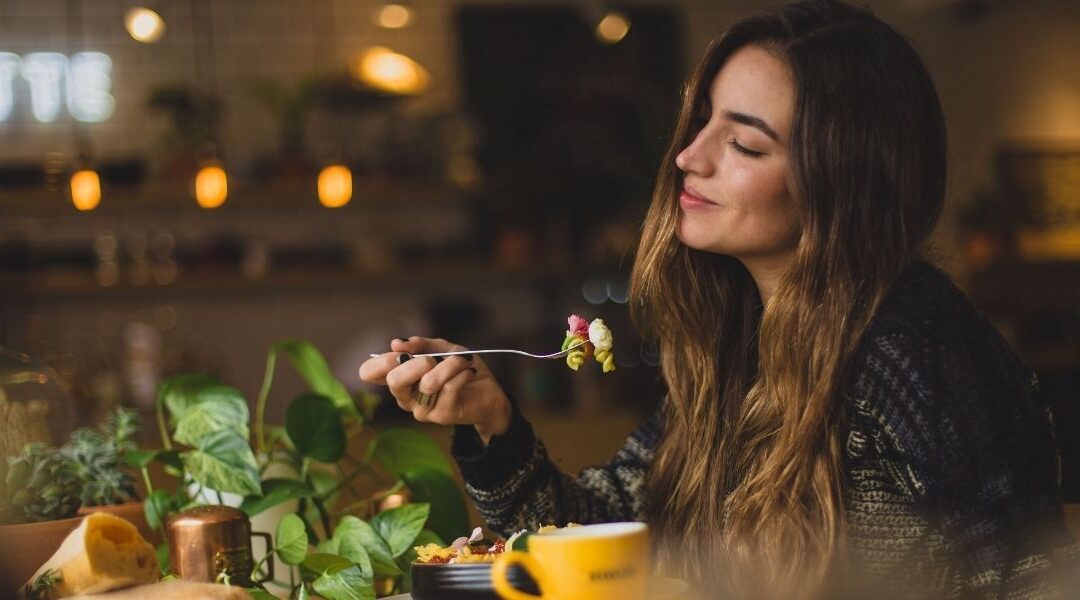 happy woman eating pasta