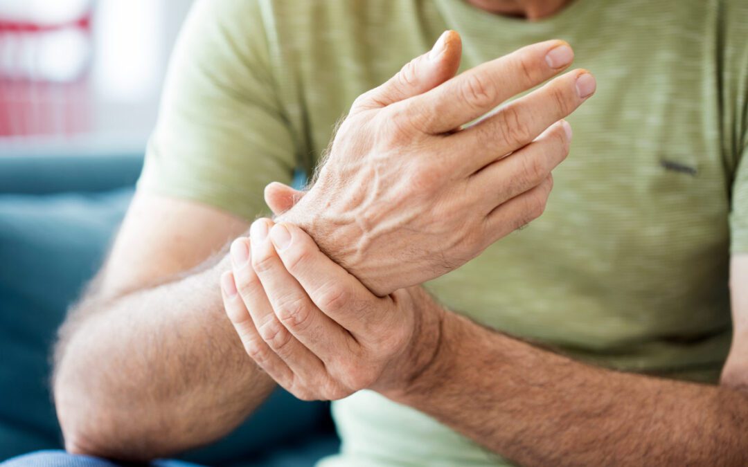 man holding his wrist cause he's in pain